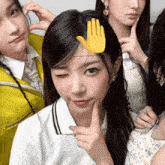 a girl with a hand on her head makes a funny face