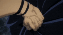 a person is holding another person 's hand with a tattoo on their wrist .