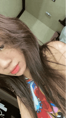 a woman with long hair is taking a selfie with her phone