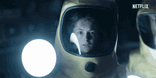 a woman in a yellow helmet with netflix on the bottom right