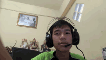 a man wearing headphones with a microphone in his mouth