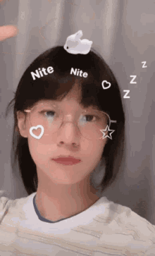 a girl wearing glasses has a bunny on her head and the words nite and nite are on her face