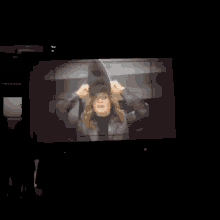a tv screen shows a man and woman dancing in a dark room