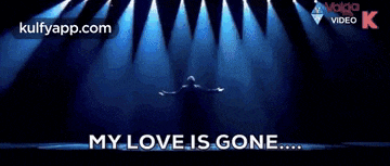 a man is standing in front of a stage with his arms outstretched and says my love is gone