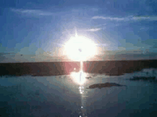the sun is shining brightly over a body of water .