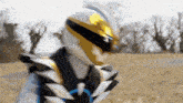 a superhero is standing in a field wearing a helmet
