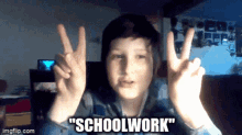 a young boy giving a peace sign with the words " schoolwork " written below him