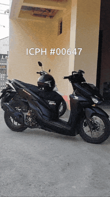 a black scooter is parked in front of a building with icph # 00647 on the bottom