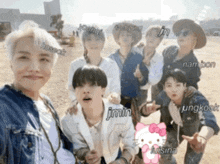 a group of young men are posing for a picture and one of them has a hello kitty sticker on his shirt