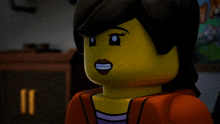 a close up of a lego girl 's face with a smile on her face