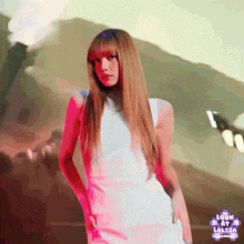 a woman in a white dress is standing in front of a sign that says " look at lalisa "