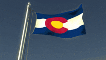 a blue white and red flag with a yellow circle in the center