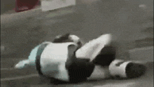 a person is laying on their back on the ground in a video game .