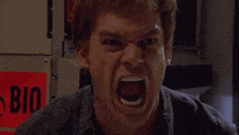 a man is screaming in front of a red sign that says bio on it