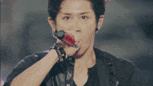 a man singing into a microphone with the letter d visible in the corner