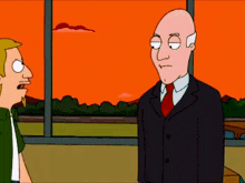 a bald man in a suit and tie stands next to a blonde man in a green shirt