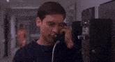 a man is talking on a pay phone that says nbc