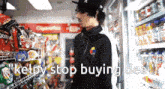 a man standing in a store with the words " kelpy stop buying deal " written below him