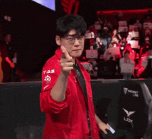 a man wearing a red jacket that says t-ax on it