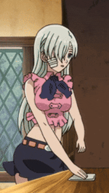a girl in a pink top is kneeling on a table