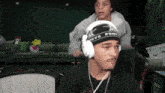 a man wearing headphones and a bandana that says ' punk ' on it