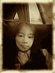 a black and white photo of a girl with a badge that says ' a ' on it