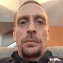 a close up of a man 's face with the words imgplay visible in the corner