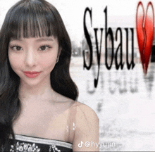 a woman is standing in front of a sybeau logo