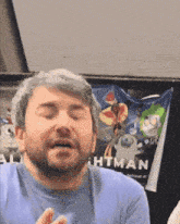 a man with his eyes closed is standing in front of a toy story sign