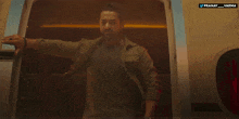 a man is standing in the doorway of an airplane with a watermark that says pranav varma
