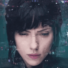 a close up of a woman 's face with a blurred background behind her .
