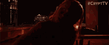 a woman is laying in a dark room with #crypttv written in the corner