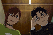 a boy and a girl are looking at something in a room