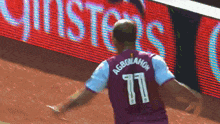 a man in a purple jersey with the number 11 on the back