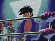 a man in a blue robe stands in a boxing ring with other men
