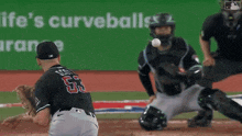 a baseball player wearing a jersey with the number 63 on it