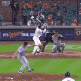 a baseball game is being played in front of an ad for miller beer