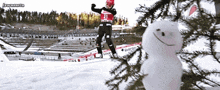 a snowman is in the foreground of a skier with the number 31 on his shirt