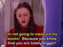 a woman in a red sweater says i 'm not going to measure my boobs !