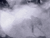 a black and white photo of a person in a smokey area