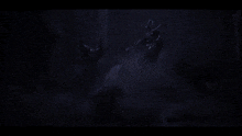 a person is swimming in the water with a blue light behind them