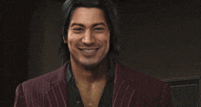 a man in a striped suit is smiling and wearing a necklace