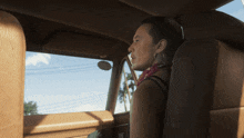 a woman is sitting in the back seat of a car
