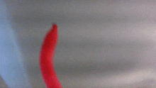 a blurry picture of a red object on a white background