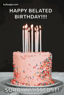 a birthday cake with candles and sprinkles is on a plate .