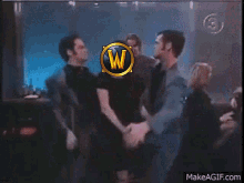 a group of people are dancing in a club with a w on their head