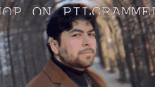 a man with a beard is standing in front of a sign that says " stop on ptt grammer "