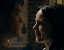 a man and a woman are looking at each other in a dark room with the word kepler in the corner
