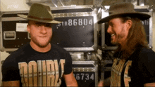 two men wearing cowboy hats and shirts that say double f