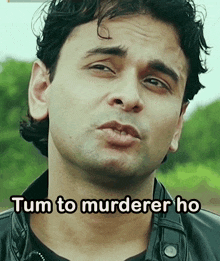 a close up of a man 's face with tum to murderer ho written below it